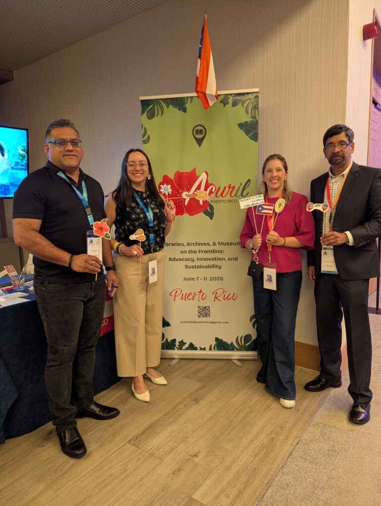 Library Transformation at ACURIL 2025 3 El equipo combinado de ACURIL, Bibliotheca y ECCA posando con banderas en su stand para la conferencia de 2026 en Puerto Rico.