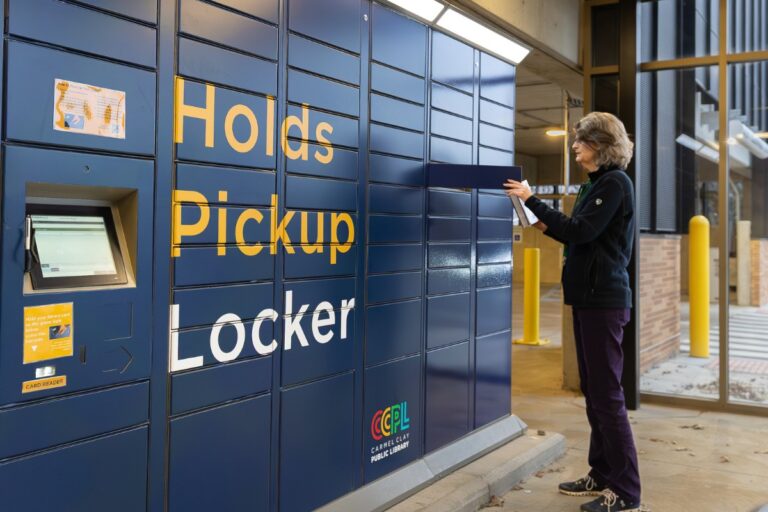 Self-Service Checkout 12 Library patron using the Bibliotheca remoteLocker at Carmel Clay Public Library to pick up reserved items.