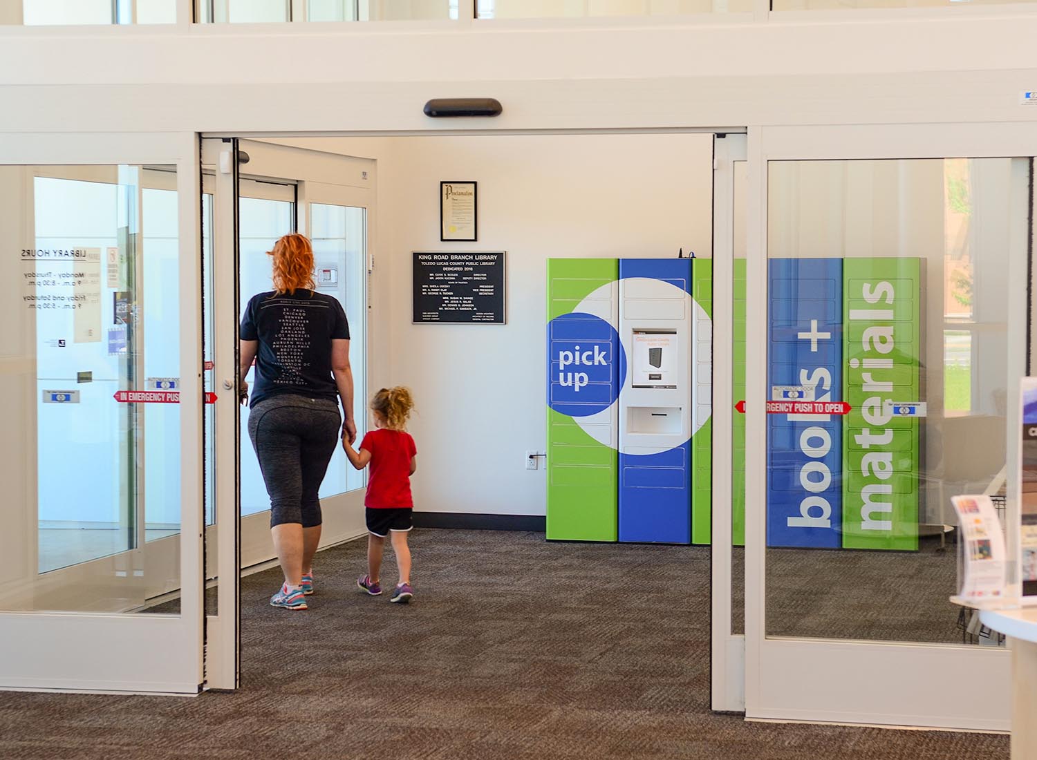 Pick Up Lockers 12 Mother and child walking out of ToledoLucas past the remoteLocker