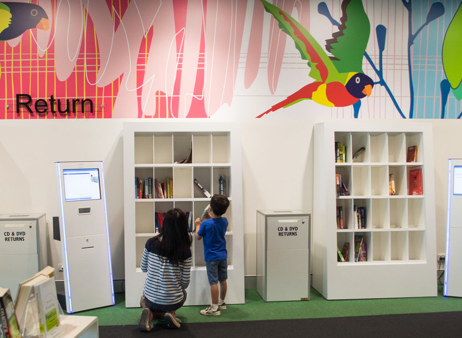 Intelligent Return Shelving 7 Mother and son browsing smartshelf in Brisbane library