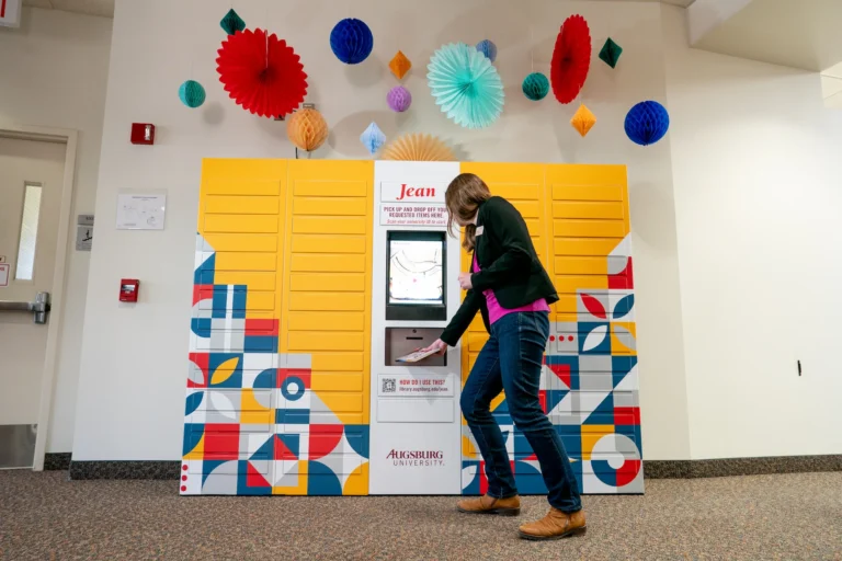 Self-Service Checkout 9 A student retrieves books from the Jean remoteLocker system at Augsburg University Library, highlighting flexible, self-service access for students.