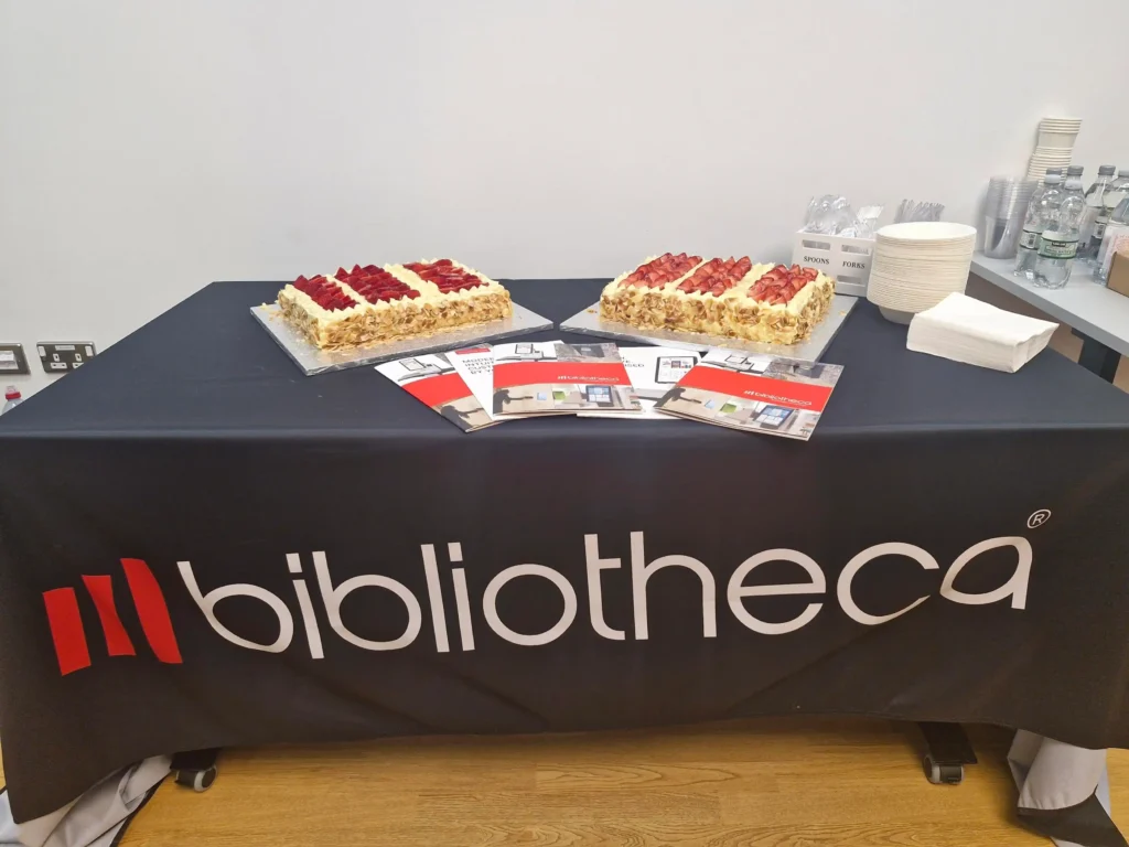North Roadshow Success: Inspiring Libraries, Sparking Ideas, and Showcasing Innovation 5 Attendees celebrating the conclusion of the Bibliotheca North Roadshow at The Stockroom with a cake