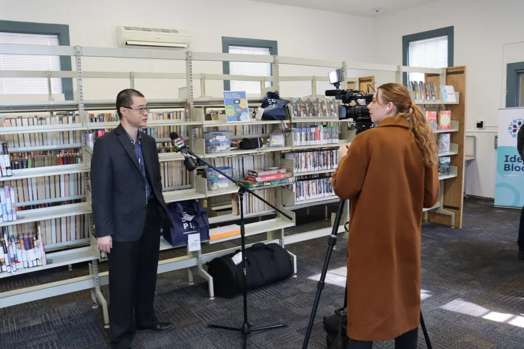 St. Catharines Public Library CEO Ken Su being interviewed about Port Plus by CHCH TV inside the Port Dalhousie Branch