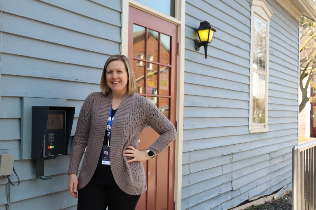 Holly Jones standing next to the open+ keypad at Port Dalhousie Branch of St. Catharines Public Library